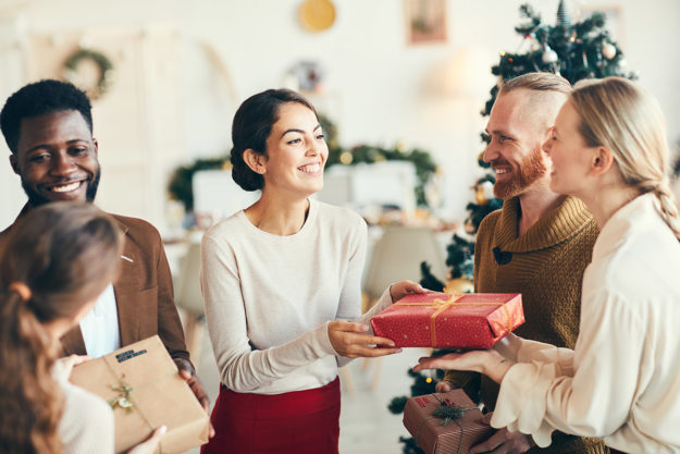 How to Enjoy the Holidays While Sober a group of people exchange gifts during sober holidays