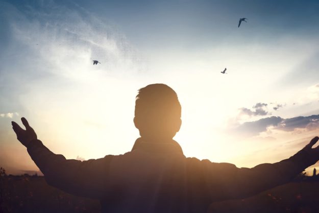 man in front of sunset