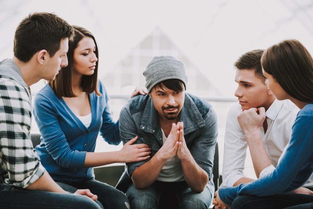 5008741 Circle of trust. Group of people sitting in circle a group of people try to convince their friend to find an addiction treatment center