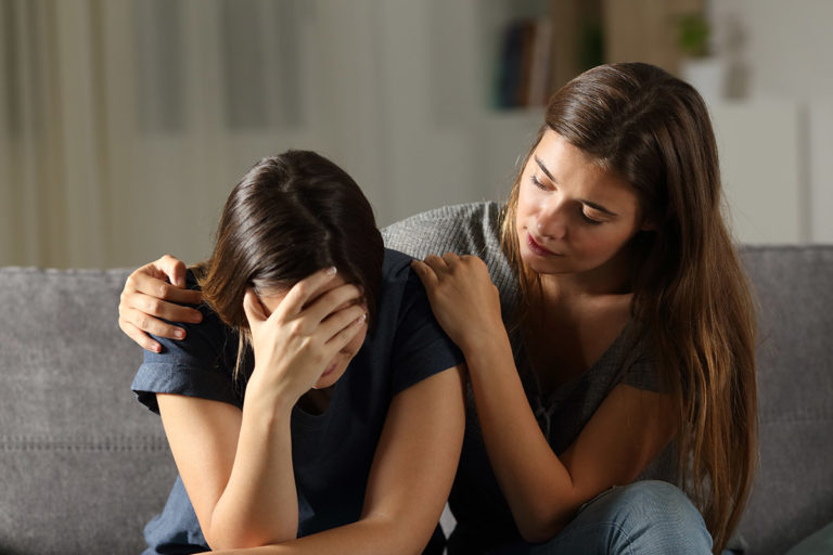 4 Signs of Self-Medication in a Loved One two friends discuss the signs of self-medication