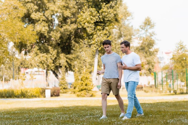 Adult _ Teen Challenge Locations a man walks with his son talking about the location for adult & teen challenge drug rehab