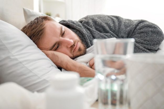 How Long Does Heroin Detox Last For a man lays in bed thinking about heroin addiction help and heroin treatment options before seeking a heroin detox program