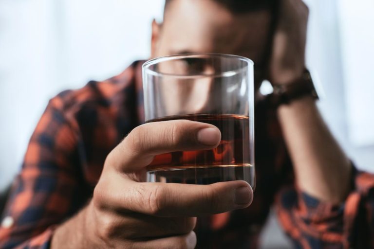 Are There Different Types of Alcoholics_ male holding whiskey in a glass