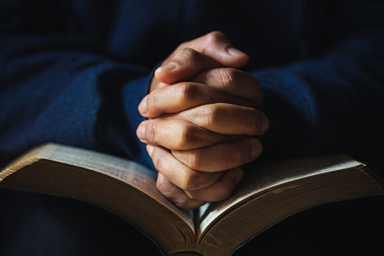 Why Should I Choose Faith-Based Addiction Rehab_ an individual prays about whether to enter faith-based addiction rehab