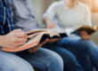 Two people with open Bibles in Christian rehab centers