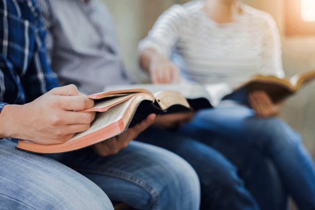 Two people with open Bibles in Christian rehab centers