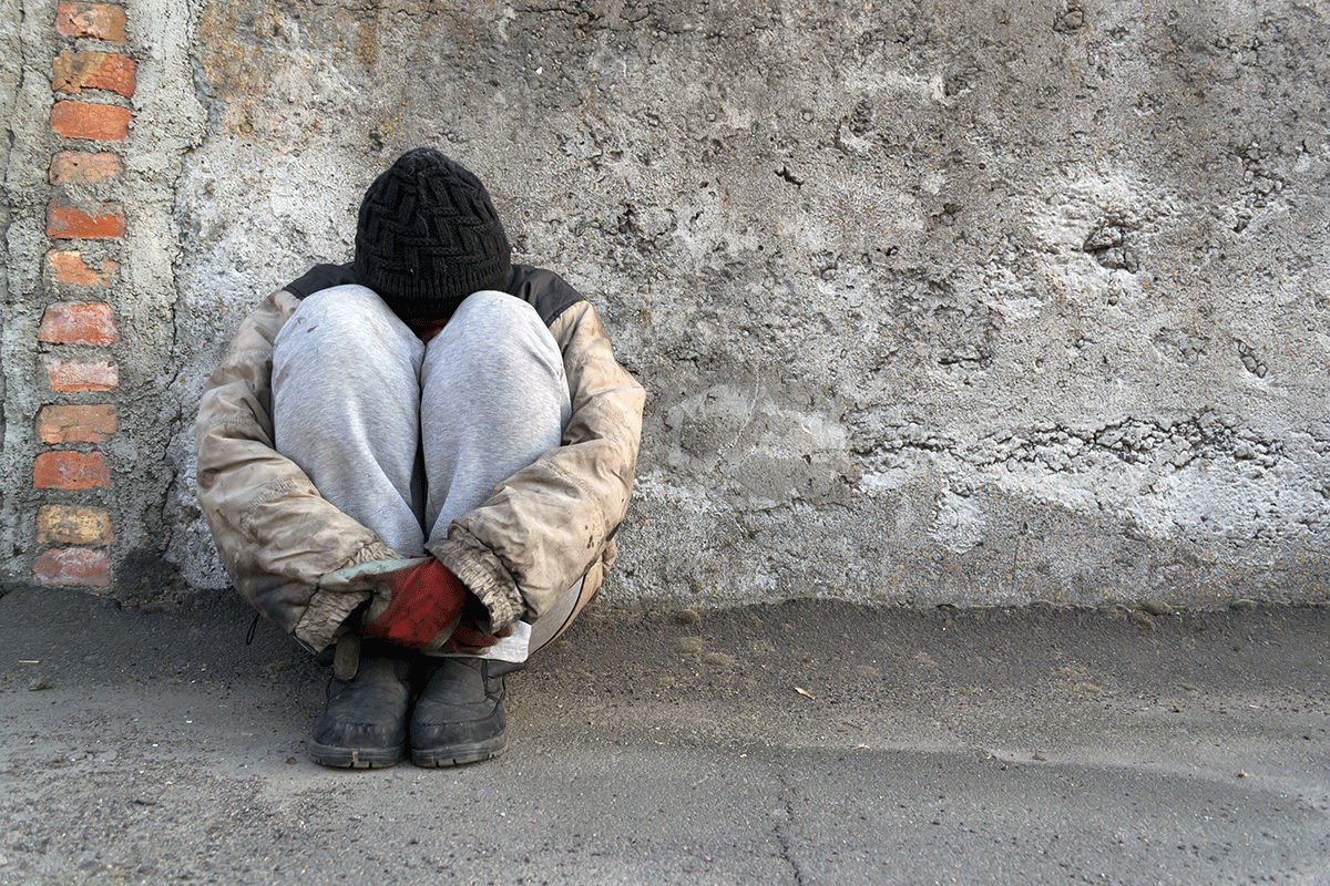 How-Homelessness-Plays-a-Role-In-Addiction A man thinking about homelessness and addiction